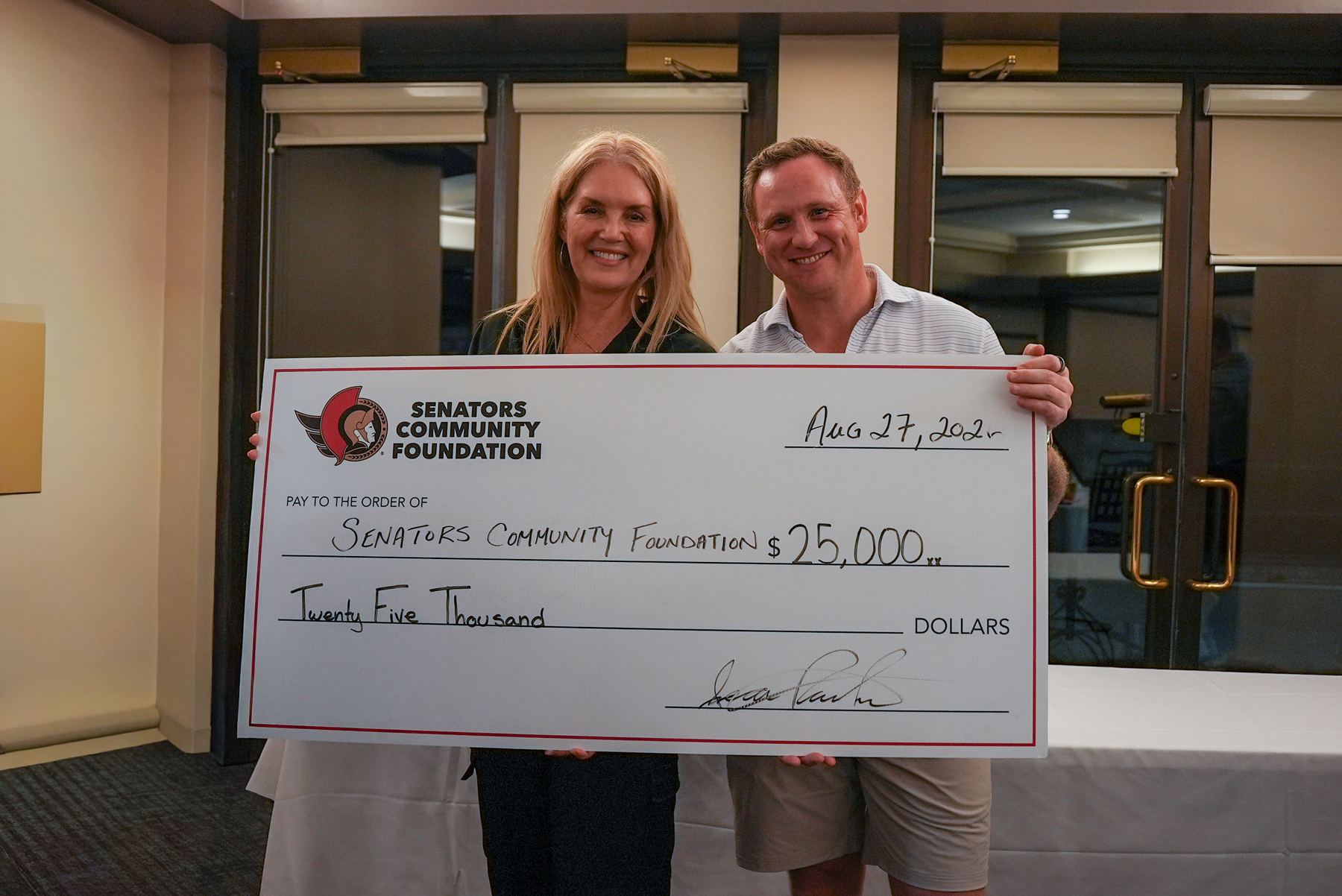 Presenting the $25,000 donation cheque to the Senators Community Foundation